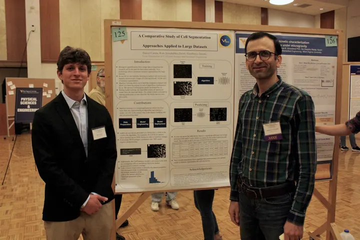 Habib Latifizadeh reviewing a student research poster