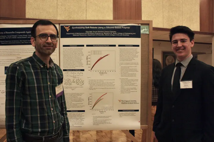 Habib Latifizadeh reviewing a student engineering poster